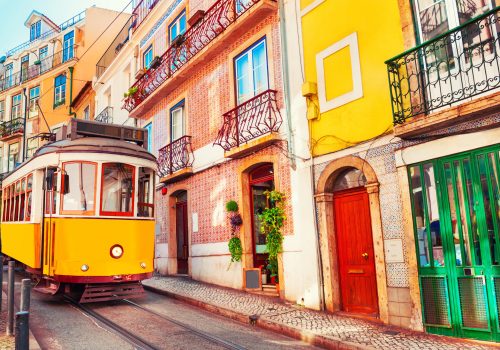 Yellow vintage tram on the street in Lisbon, Portugal. Famous travel destination