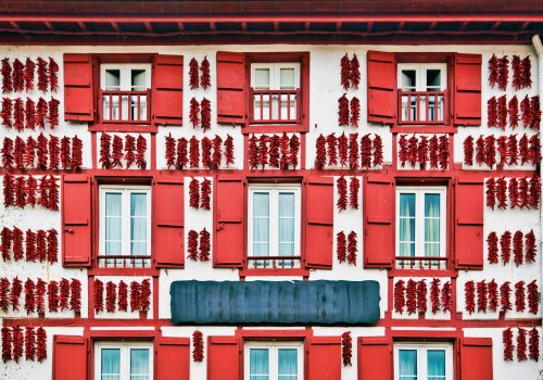 Red Espelette peppers drying in the wall of a traditional Basque house in Espelette village, Basque province of Labourd, France, Atlantic Pyrenees, Aquitaine