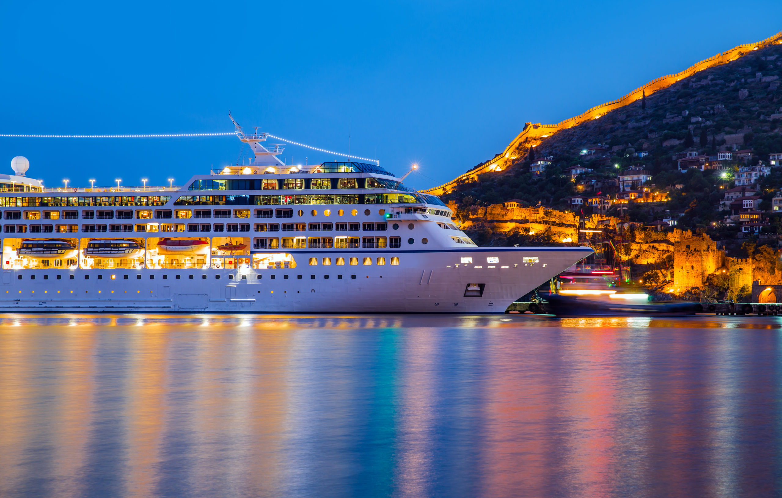 Beautiful white giant luxury cruise ship on stay at Alanya harbor