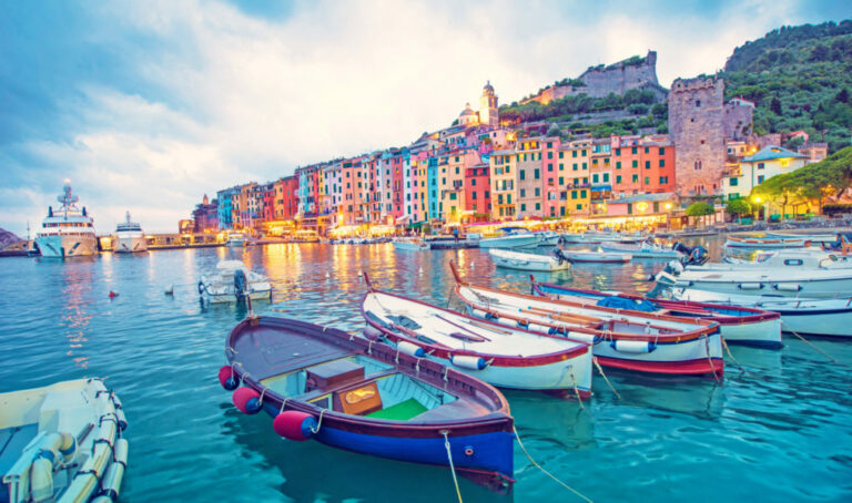 Mystic landscape of the harbor with colorful houses and the boats in Porto Venero, Italy, Liguria in the evening in the light of lanterns