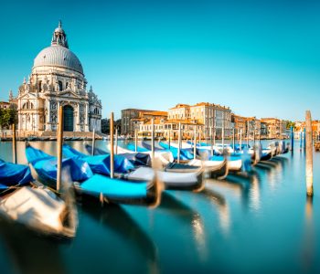 Venice cityscape view on Santa Maria della Salute basilica with gondolas on the Grand canal in Venice. Long exposure image technic with motion brured boats