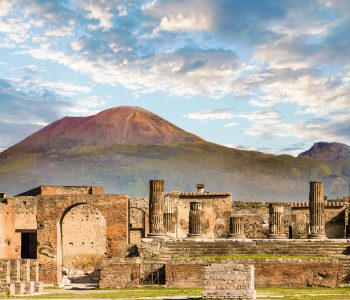 Ancient walls in Pompeii with volcano Vesuvius in the background