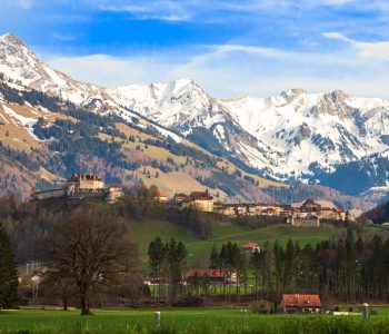 Medieval Town of Gruyeres and Castle with mountains in the background, Canton of Fribourg in Switzerland