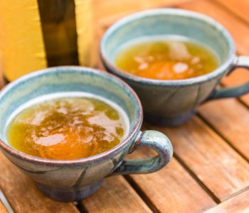 Norman apple cider in a typical ceramic cups. Shot with a selective focus